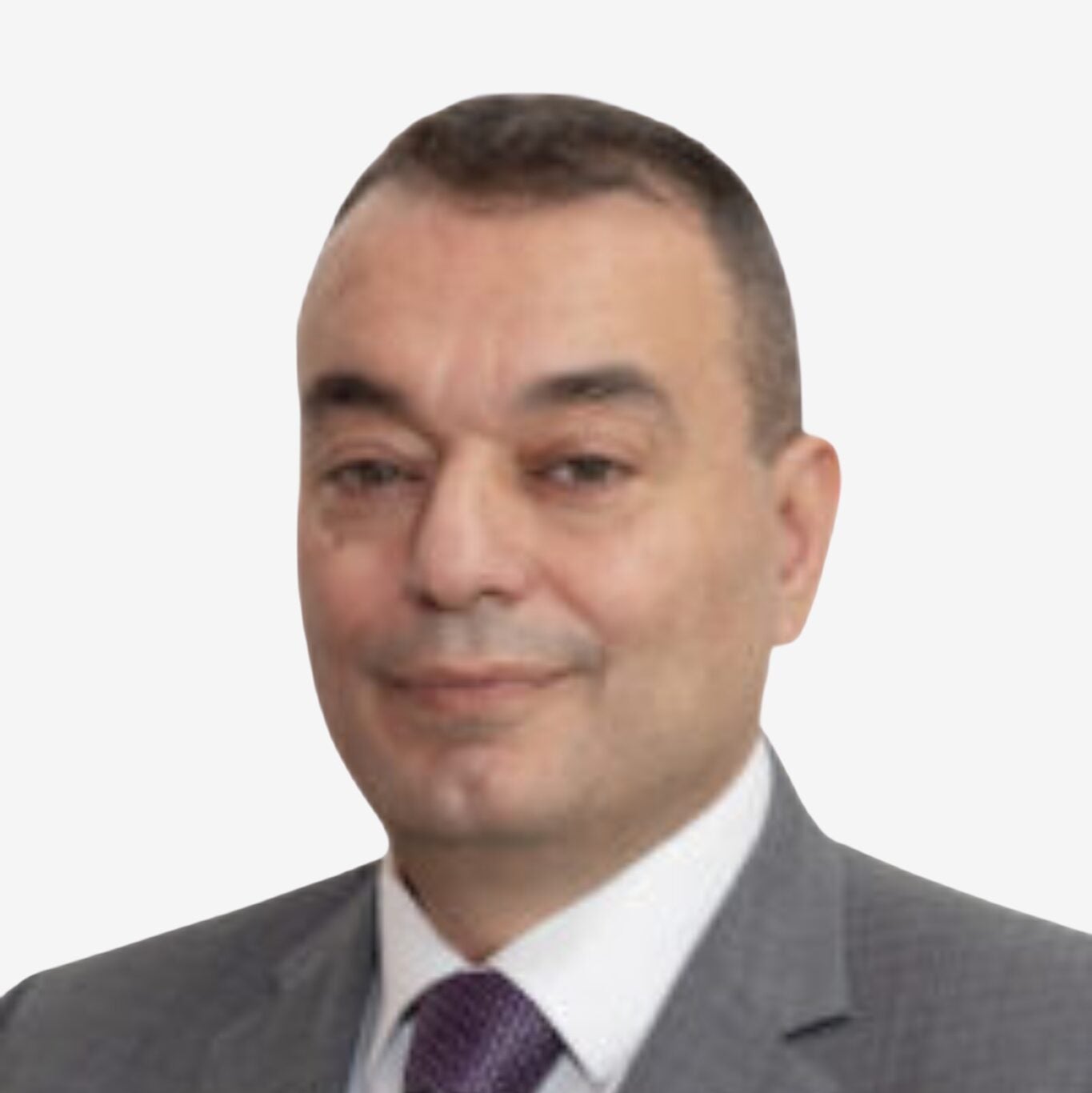 Rodolph Boughaba is wearing a gray suit with a purple tie and looking at the camera